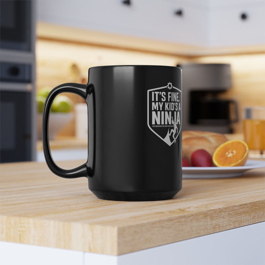 Black 15oz Mug — “It’s Fine, My Kid’s a Ninja” Parent Coffee Cup
